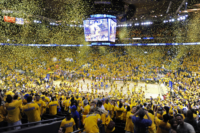 Warriors fans celebrate as confetti drops from the ceiling as they celebrate their win over the Los Angeles Clippers in Game 6 of their Western Conference NBA playoff game at Oracle Arena in Oakland, Calif., on Thursday, May 1, 2014. The Warriors defeated the Clippers 100-99. (Jose Carlos Fajardo/Bay Area News Group)